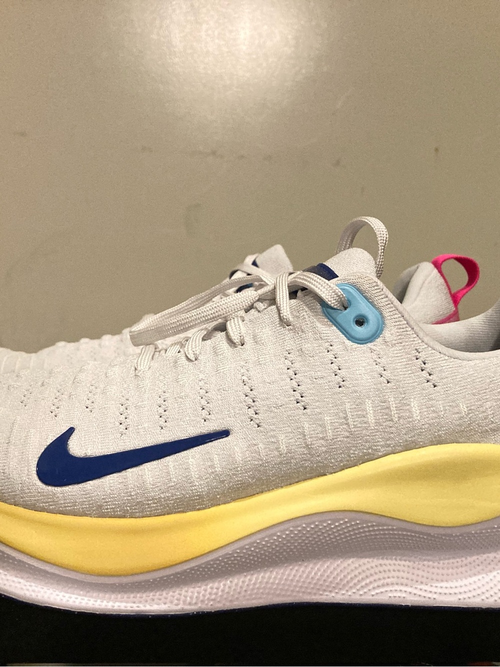 Nike White Athletic Shoes with Blue Swoosh and Yellow Midsole